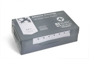 A grey box labelled Fabric Plasters (120 Assorted) contains 120 elastic fabric plasters by Click Medical. The box displays medical symbols and product information on the top and sides. | Work & Wear DIrect