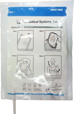 A sealed package labelled "NF 1200 Adult Electrode Defib Pads (1 PAIR) - CM0486" displays illustrated instructions, with text and safety symbols, showing a four-step process for applying the medical pads to a person’s chest. | Work & Wear DIrect