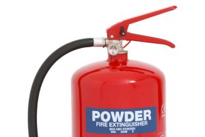 A Firechief XTR 9kg Powder Fire Extinguisher (FXP9) featuring a red body, black hose, pressure gauge, and labelled "POWDER FIRE EXTINGUISHER" on the front. | Work & Wear DIrect