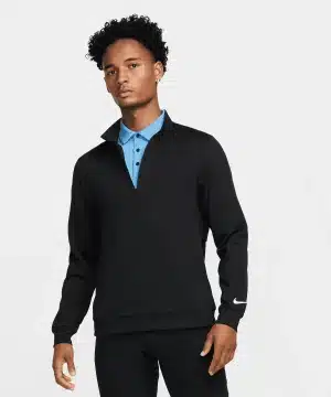 A person wearing a black quarter-zip Nike pullover over a blue collared shirt stands against a plain white background, looking ahead with a neutral expression. | Work & Wear DIrect