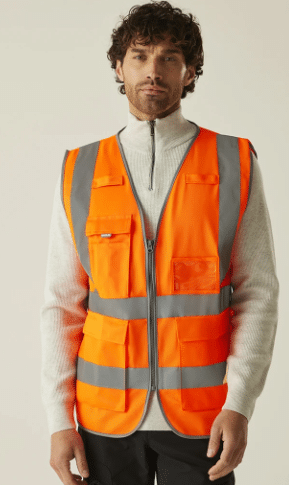A person wearing a white jumper with a zip and an orange reflective safety vest stands against a plain background, looking forward. | Work & Wear DIrect
